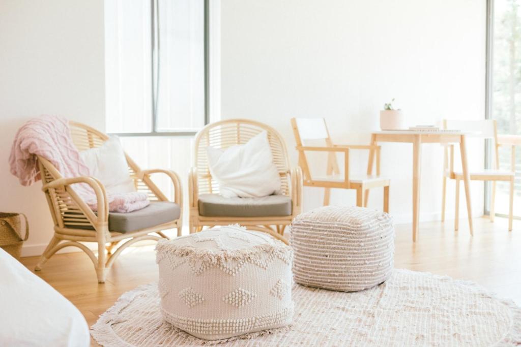 a living room with two chairs and a table at Franklin's Place in Belmont