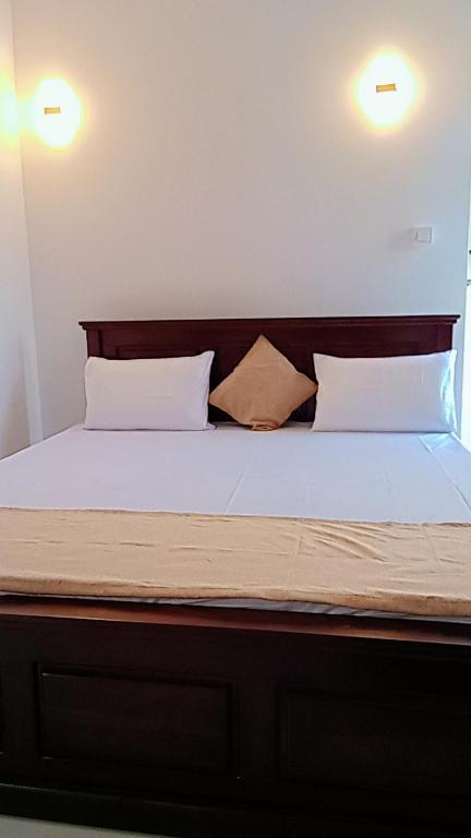a bed with white sheets and two pillows at Horton Grand Boralanda in Haputale
