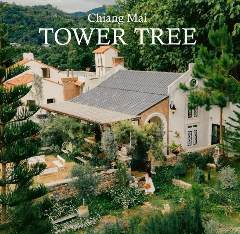 a book cover of a house with a tree at Home Tower tree เชียงใหม่ in Pong Yaeng