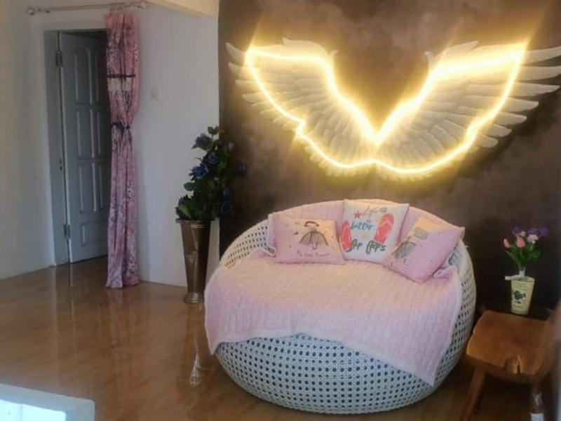 a room with a bed with wings on the wall at FM Homestay Banyuwangi in Banyuwangi
