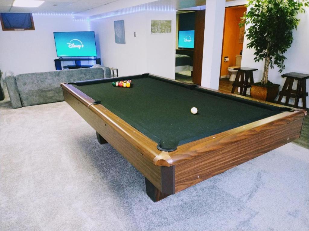 a billiard table in a living room with afits at Charles Stays in Kansas City
