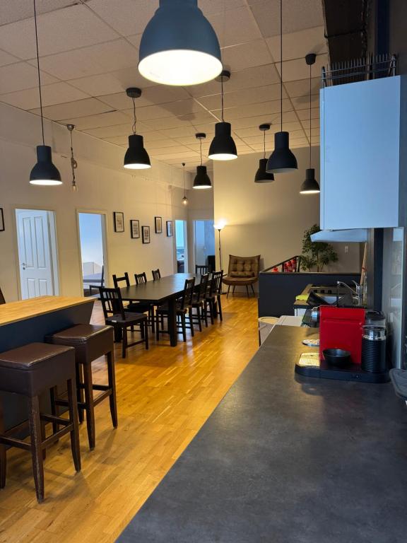 a dining room with a table and chairs and lights at City Room 2 Stuttgart-Mitte in Stuttgart