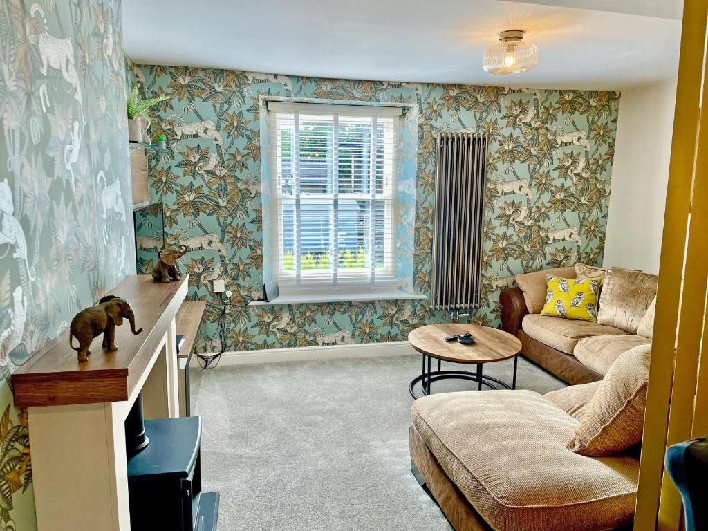 a living room with a couch and a table at Station View in Pickering
