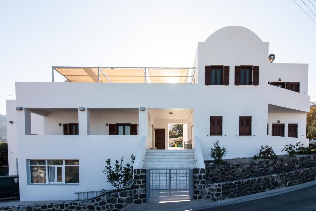 a white house with a staircase in front of it at La Noi Houses in Éxo Goniá