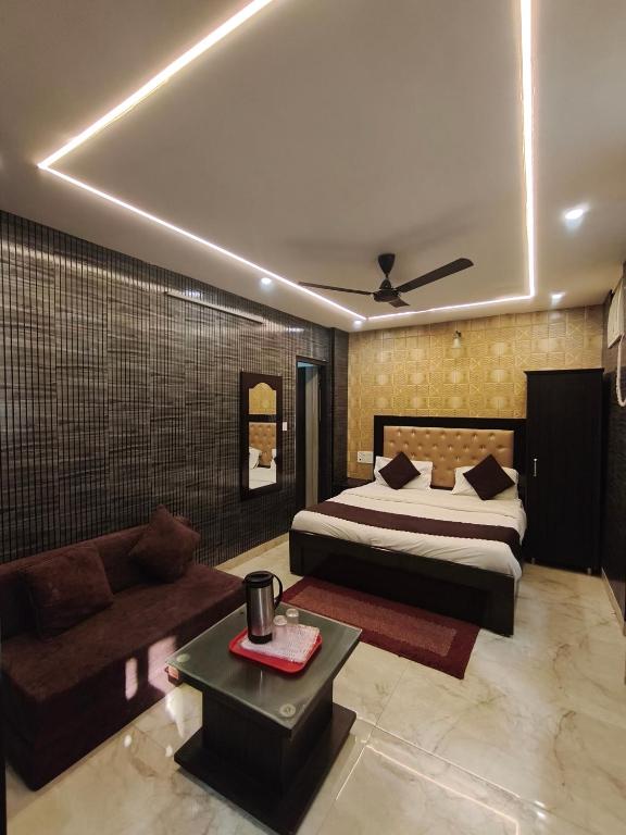 a bedroom with a bed and a couch at Hotel Gulmohar in Haridwār