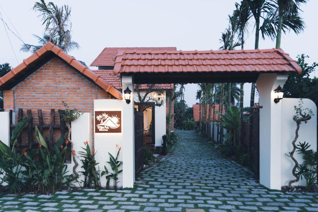 a walkway leading to a house with a gate at Homestay Mộc An in Lagi