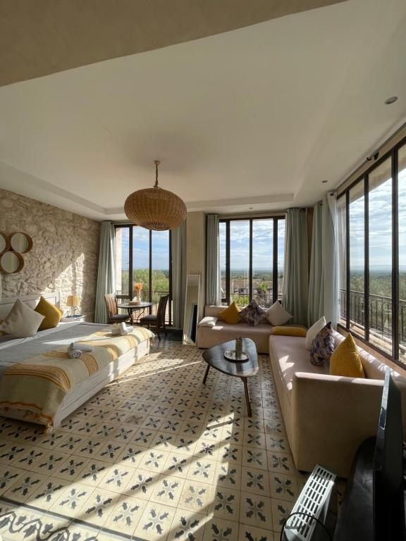 a bedroom with a large bed and a couch at Villa Mamma Giò in Essaouira