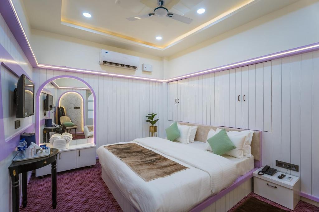 a bedroom with a large bed and a mirror at Shri Prem Villa in Jaisalmer
