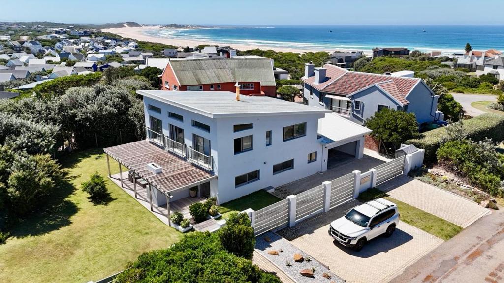 an aerial view of a house with a car parked in the driveway at Sunny Beach House in Cape St Francis