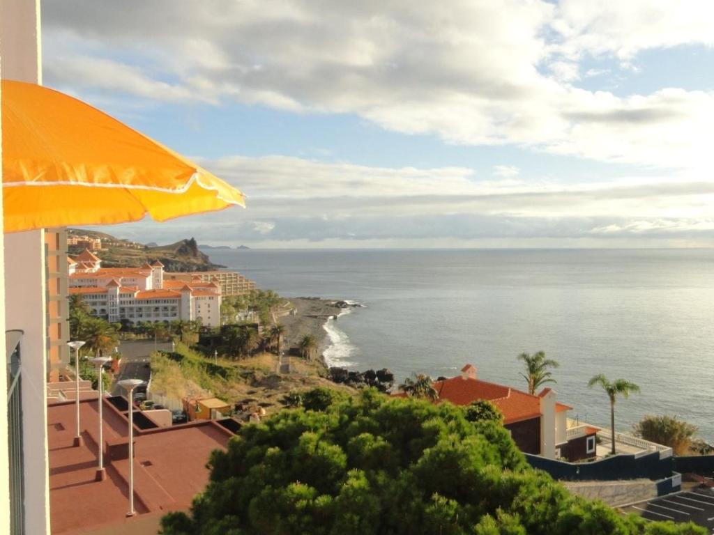 a view of the ocean from a building at Apartment Palma Madeira wandern und tauchen in Caniço