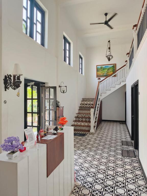 a hallway of a house with a staircase at Homestay Harmonie Cepu in Padangan