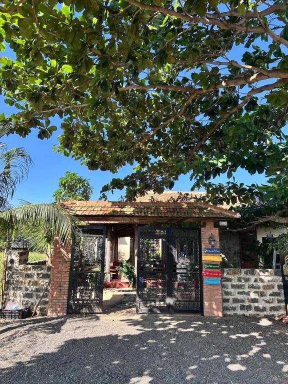 a brick building with a gate in front of it at An's House - Đóng trên booking - LH trực tiếp in Phan Thiet