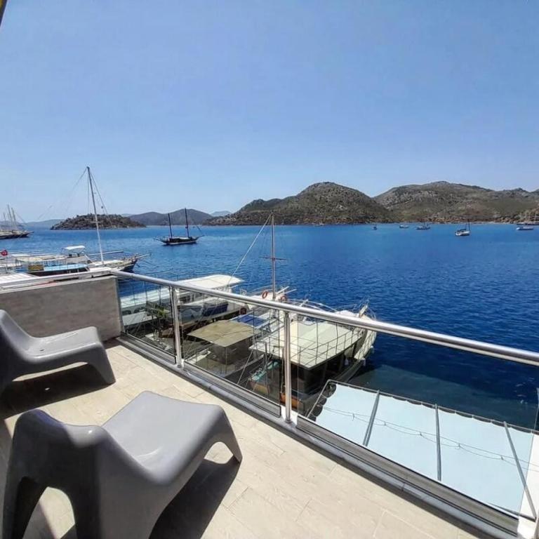 a bench sitting on the deck of a boat in the water at Buena Vista Hotel&Restaurant in Marmaris