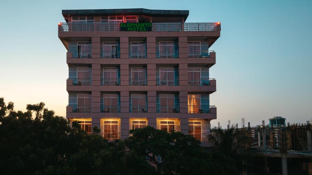 a tall building with a sign on top of it at Elephanto Hotel LTD in Zanzibar City