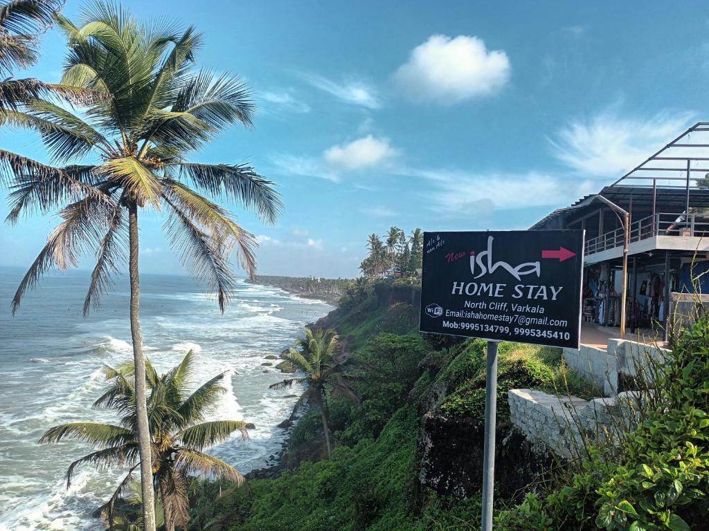 a home stay sign next to the ocean at isha homestay in Varkala