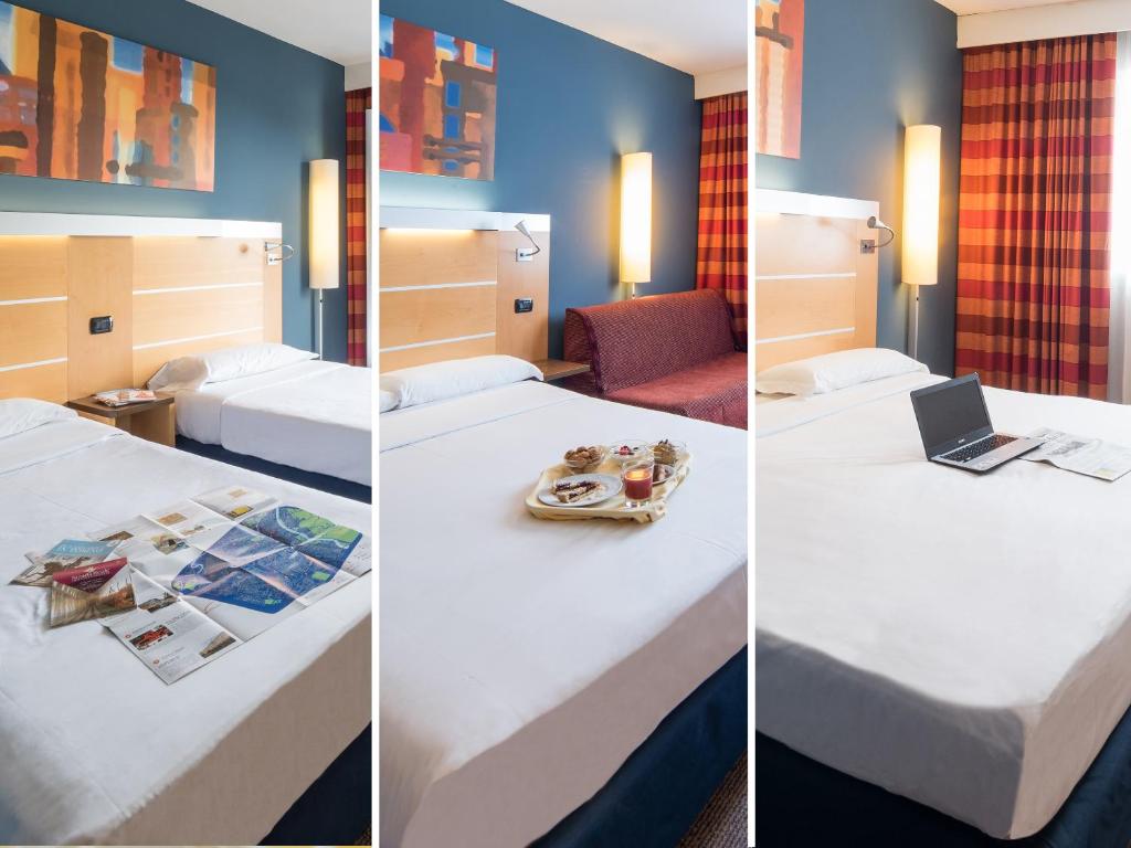 A bed or beds in a room at Idea Hotel Torino Mirafiori