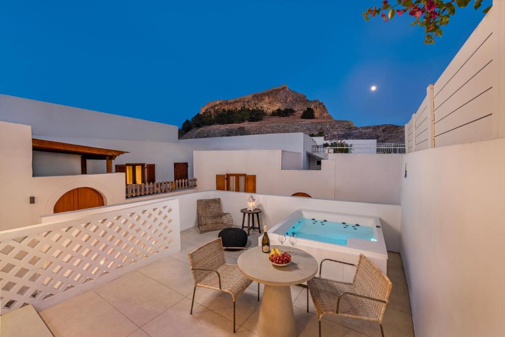 a villa with a swimming pool and a patio at Kantouni Lindos ELEGANT APARTMENT in Lindos