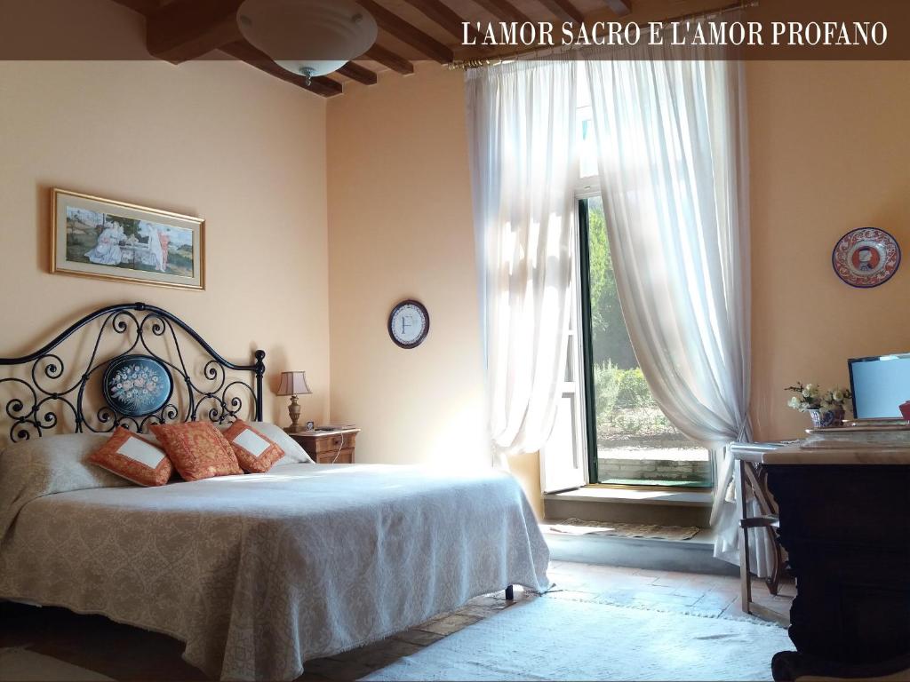 a bedroom with a bed and a large window at Vescovado 7 in Gubbio