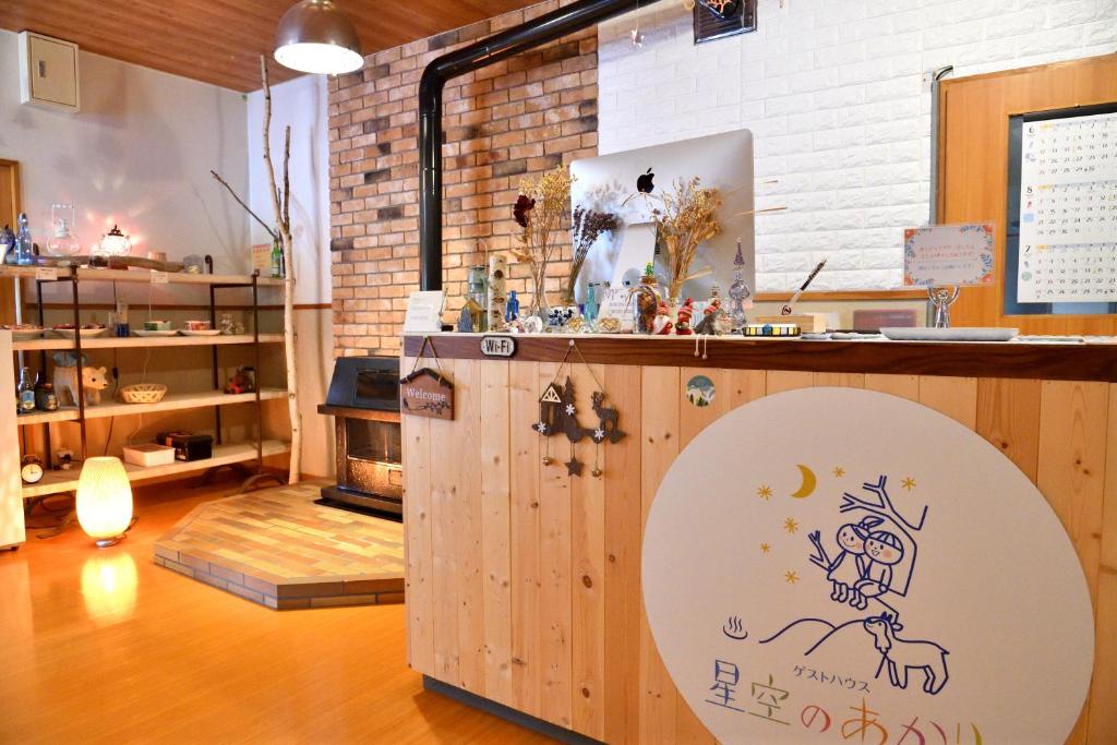 a room with a counter with a drawing on it at Guesthouse Hoshizora no Akari in Matsumoto