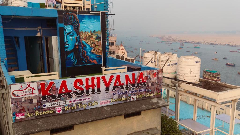 a sign on the side of a building next to the water at Kashiyana in Varanasi