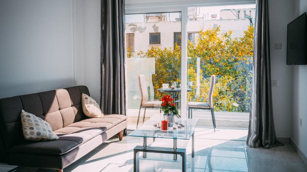 a living room with a couch and a table at Midtown Napa Apartments in Ayia Napa