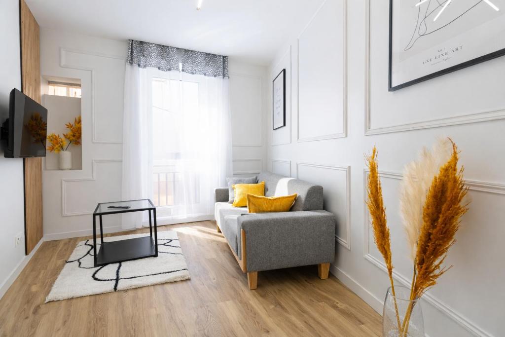 a living room with a couch and a table at joli & charmant au centre Millau in Millau