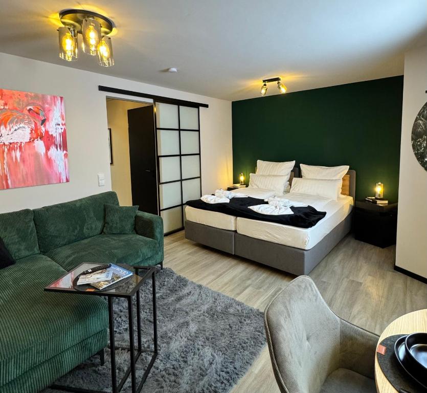 a living room with a bed and a couch at Ankommen & wohlfühlen - Ihr stilvolles Zuhause in Dresden