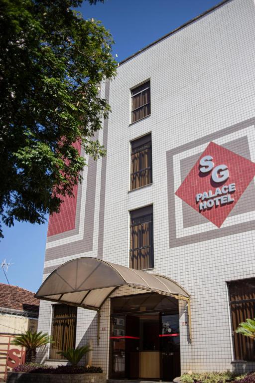 a building with a sign on the front of it at SG Palace Hotel in Taubaté