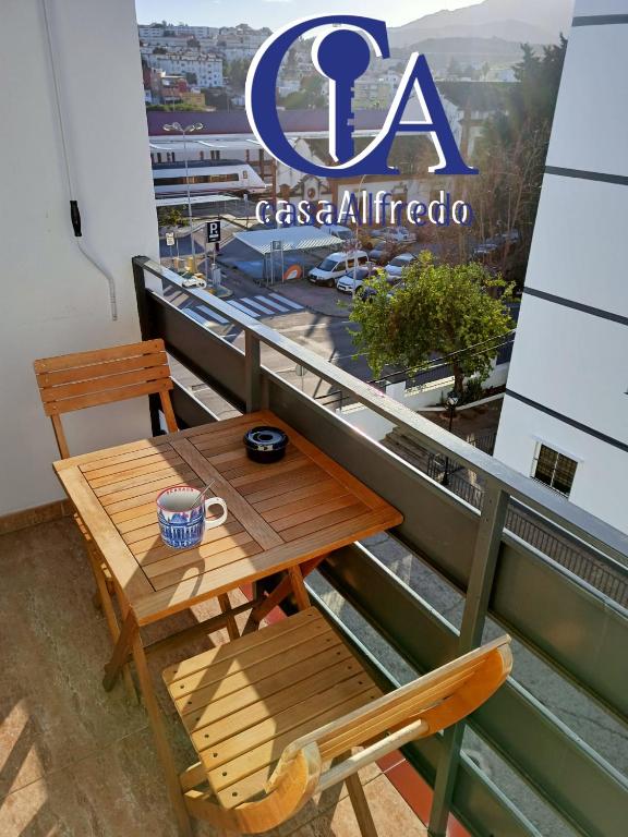 a table and chair on the balcony of a building at Hospedaje casaAlfredo, guest house in Algeciras