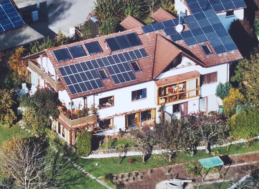 an aerial view of a house with solar panels on the roof at Gästehaus Cavallo in Achberg