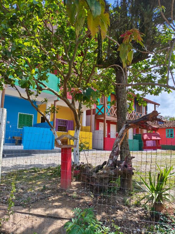 a playground in front of a colorful building at Pousada Alforria Lavras Novas centro in Lavras Novas