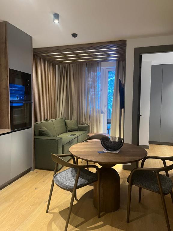a living room with a table and a couch at Apartman hotel 507 in Jahorina