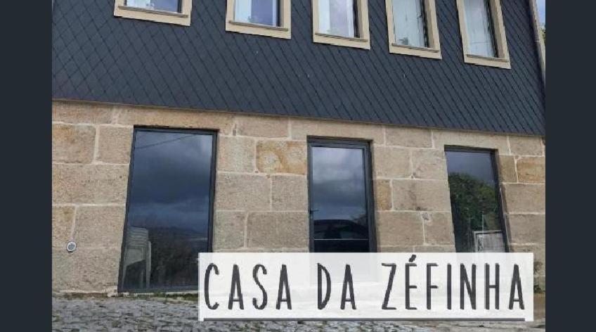 a building with a sign in front of it at Casa da Zéfinha - STUDIO in Cinfães