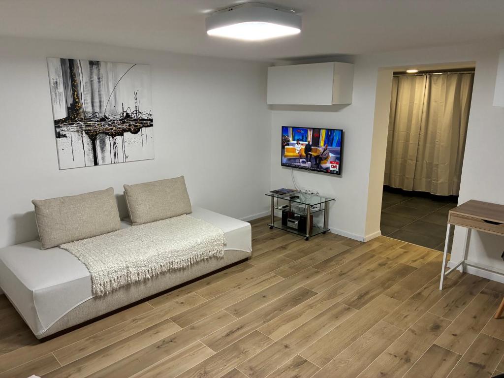 a living room with a couch and a flat screen tv at City center in Čadca