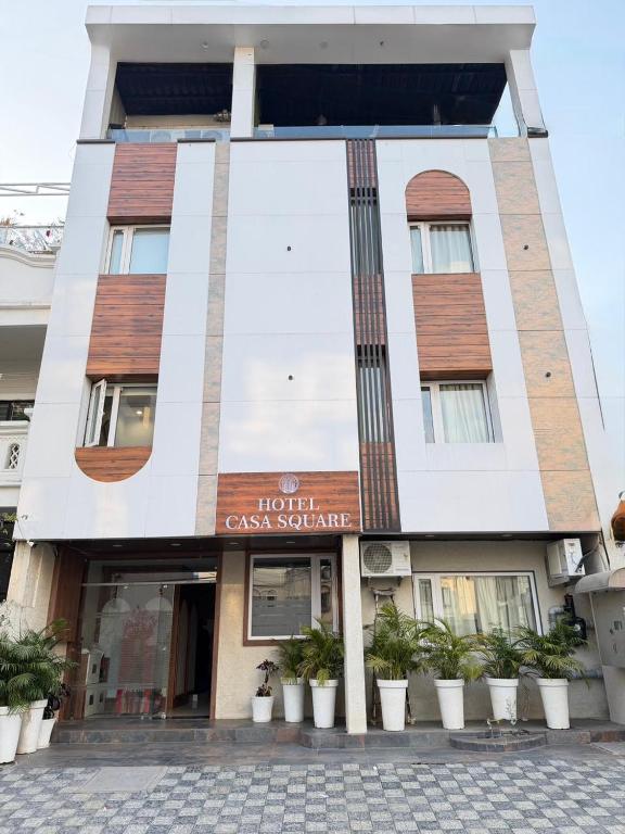 a hotel with a sign on the front of a building at Hotel Casa Square in Indore