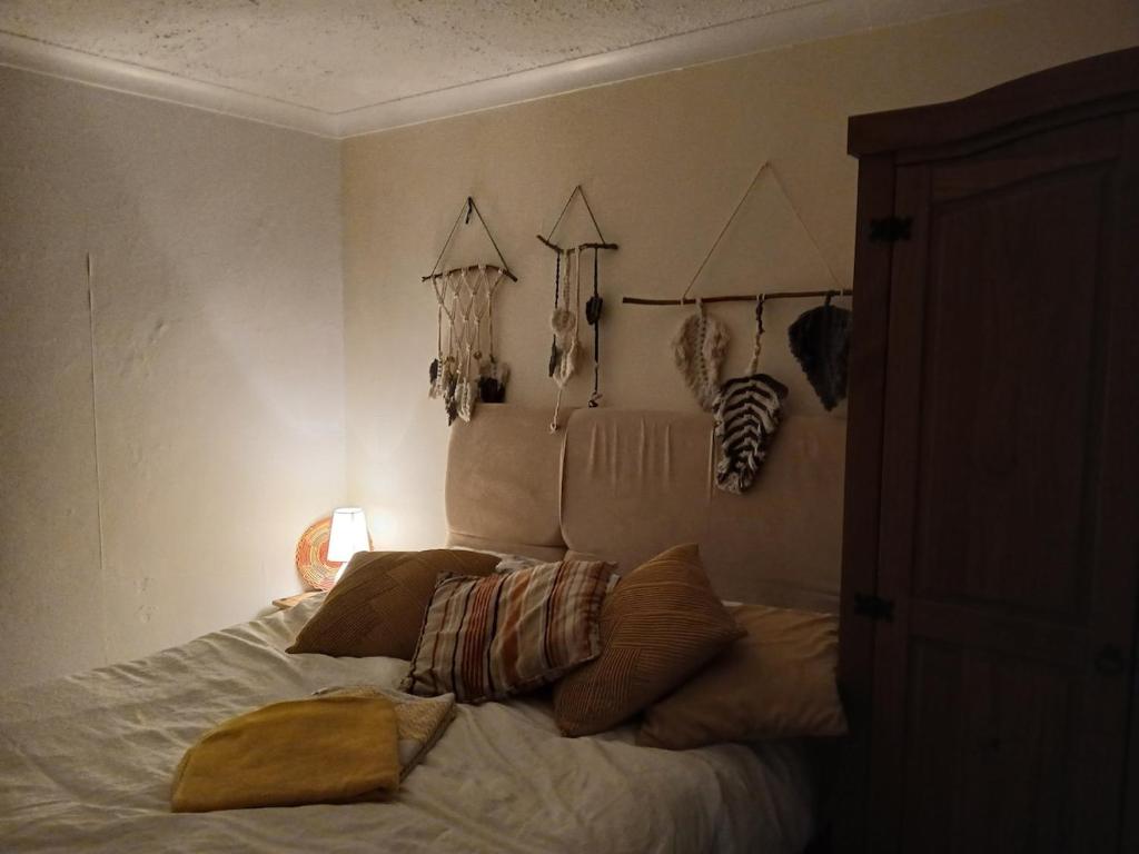 a bedroom with a bed with pillows on it at Self contained 1 bedroomed garden flat in Abersychan