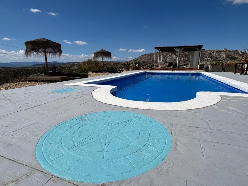 a large swimming pool with a blue pool at Ruime cortijo met zwembad in Andalusië ideaal voor families & groepen 3 appartementen in Huércal-Overa