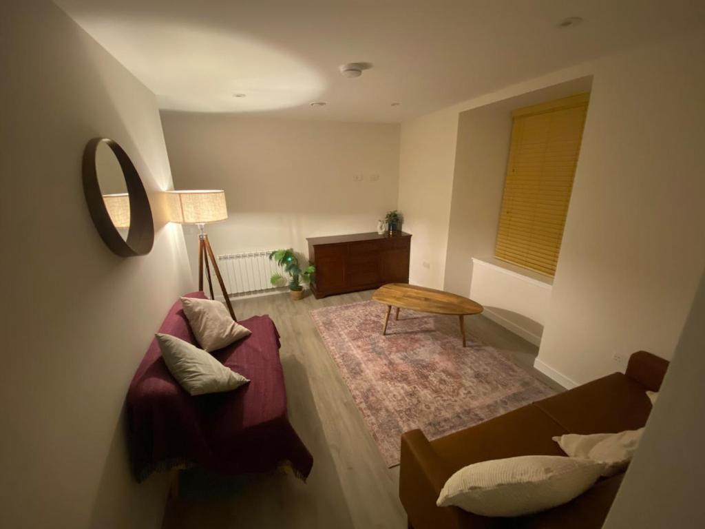 a living room with a couch and a table at St Magnus Retreat in Lerwick