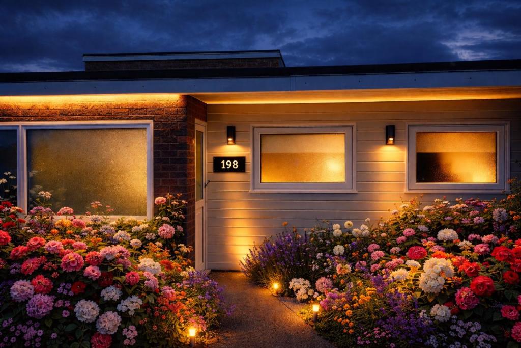 a house with a bunch of flowers in front of it at 198 Headwards Retreat in Hemsby