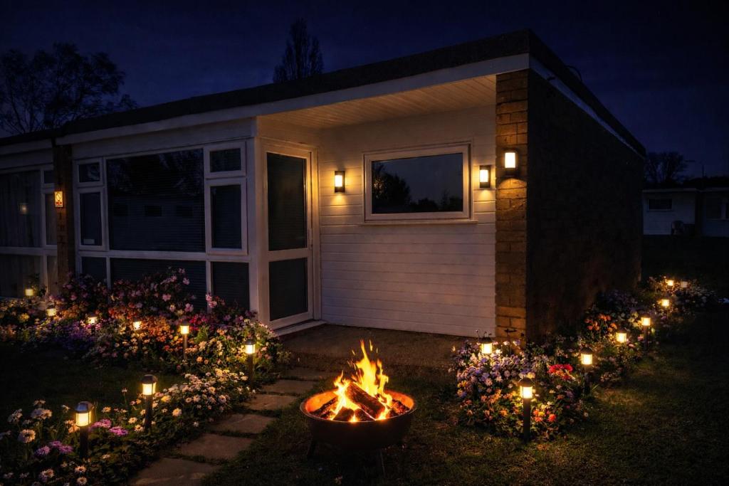 a backyard fire pit in front of a house at night at 11 Headwards Retreat in Great Yarmouth