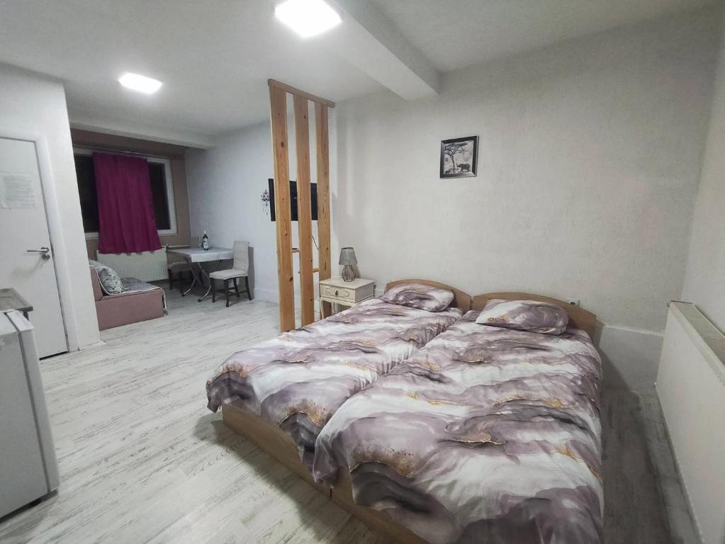 a bedroom with a bed and a living room at Villa DIJA in Kruševo