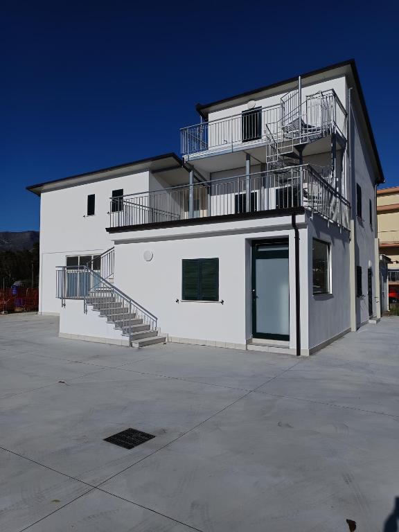 a white building with stairs on the side of it at Villa Ranucci Formia guesthouse in Formia