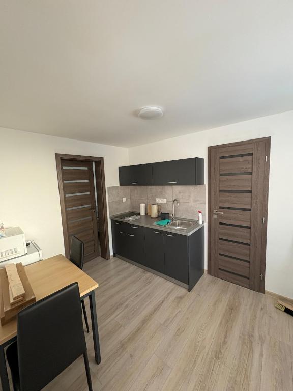 a kitchen and dining room with a table and a table and a kitchen at Apartman pri kostole in Krásno nad Kysucou