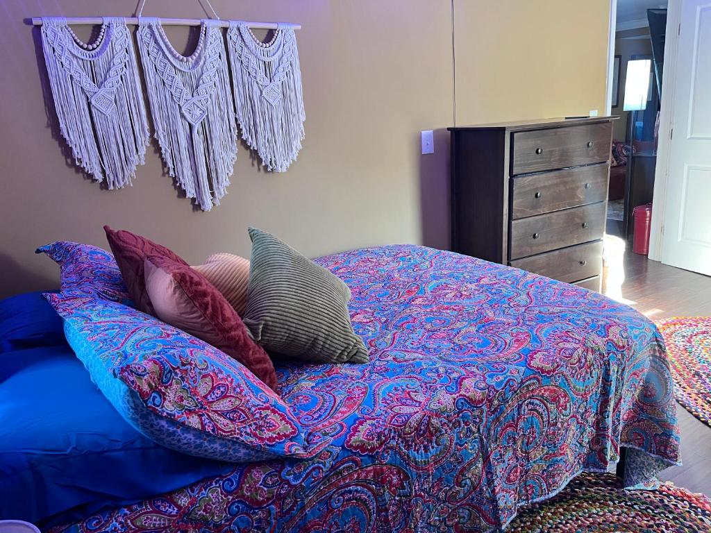a bedroom with a bed with pillows and a dresser at The Bay House in Shady Side