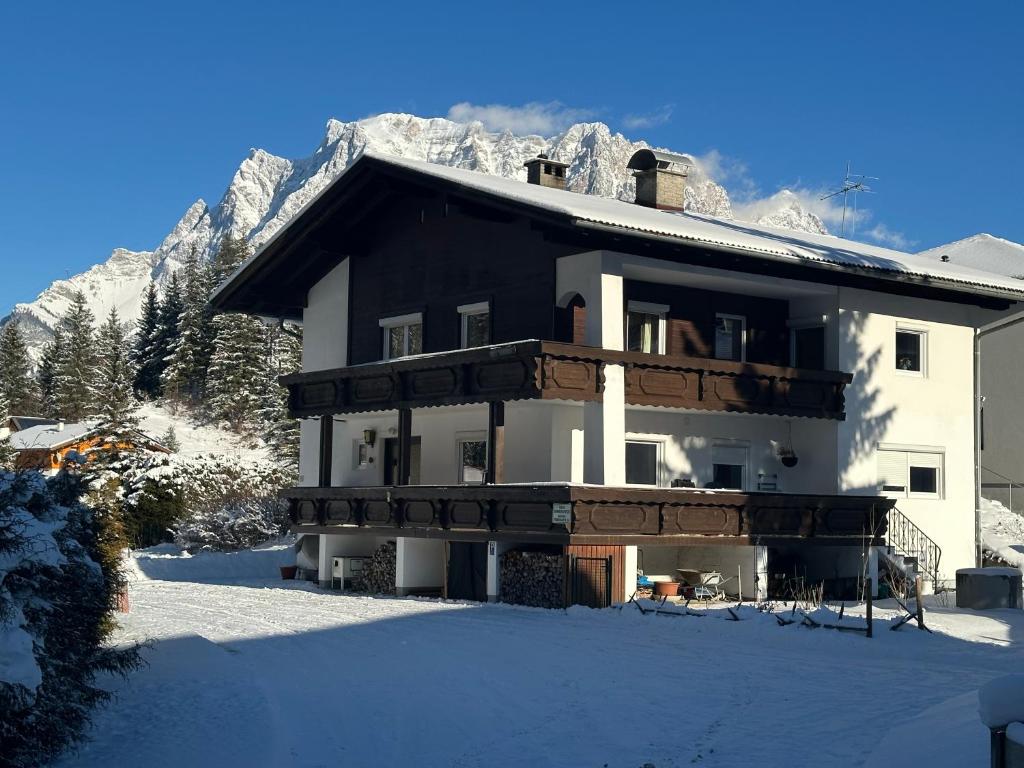 a house in the snow with a mountain at Haus Sonnenspitze - Fam. Nessler in Biberwier