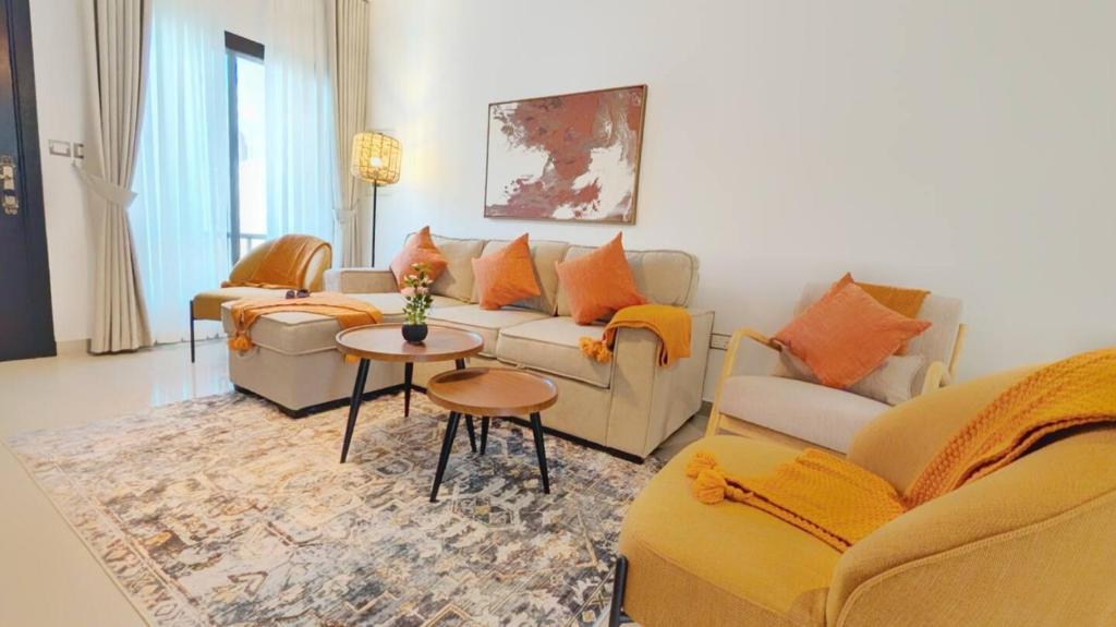 a living room with couches and a table at Family Friendly Villa in Abu Dhabi
