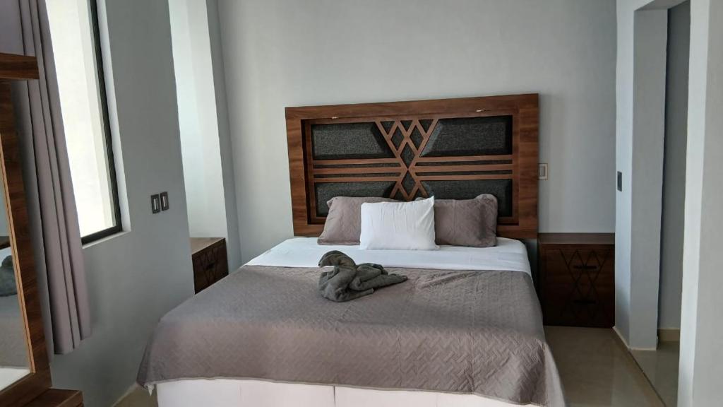 a bedroom with a bed with a stuffed animal on it at Cuarto en casa de campo in Arandas