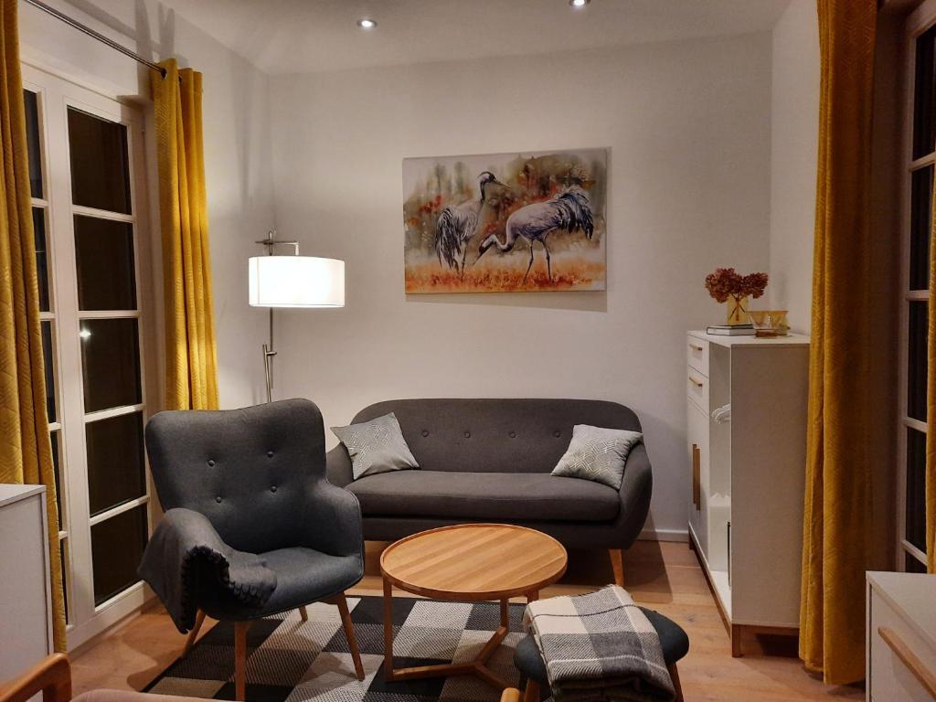 a living room with a couch and a table at Seeapartment Wustrau in Wustrau
