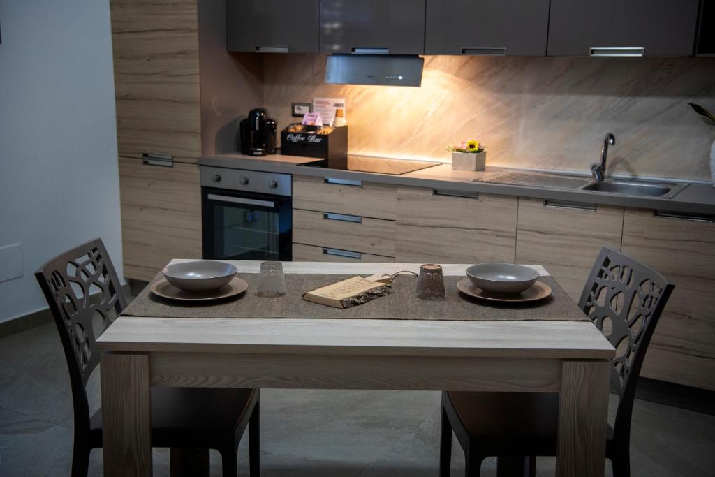 a kitchen with a table with two bowls on it at La Lanterna in Giovinazzo