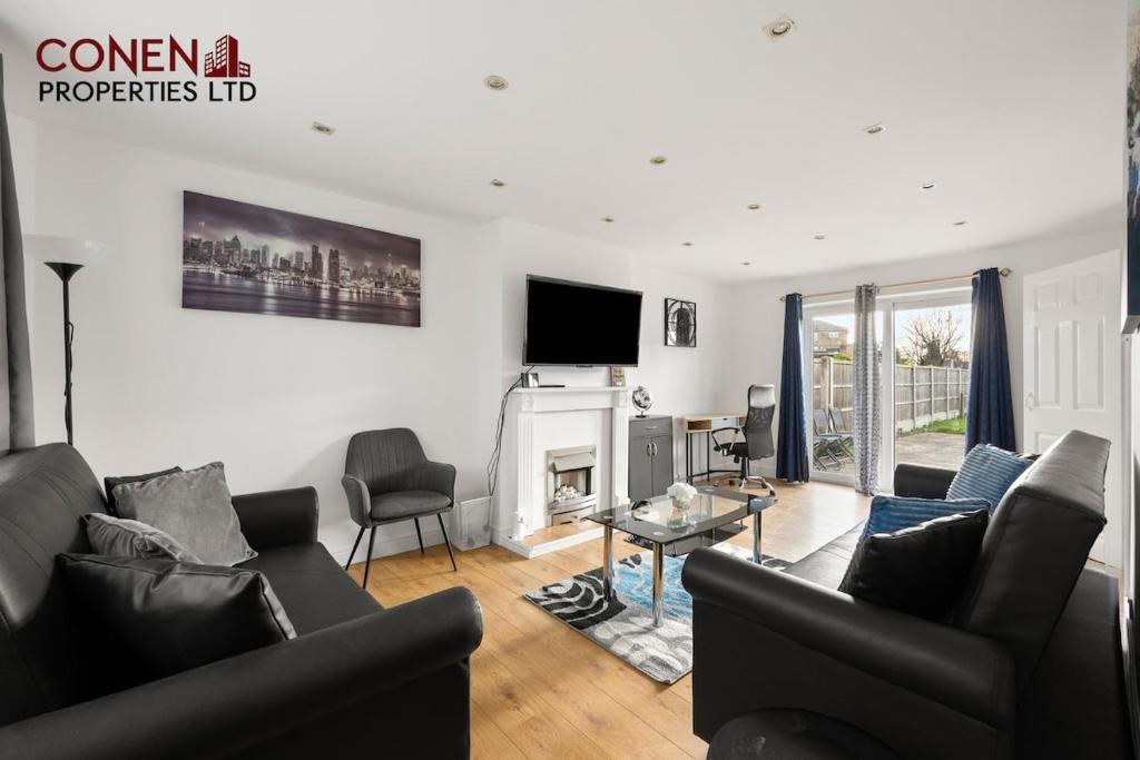 a living room with a couch and a fireplace at CONEN Morant Place in Grays Thurrock